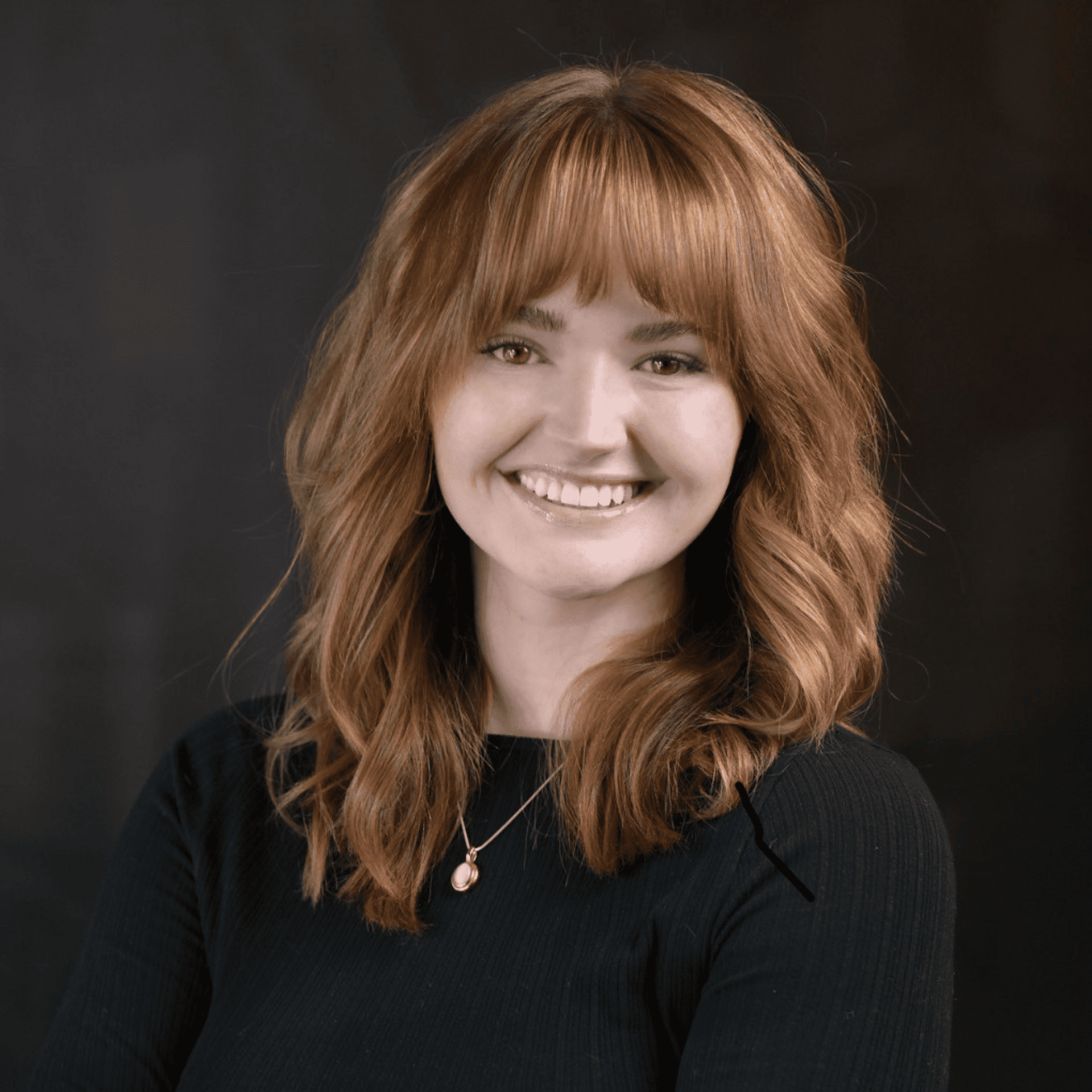 Portrait of Maya, a professional stylist at Chad + Co., showcasing their expertise and style.