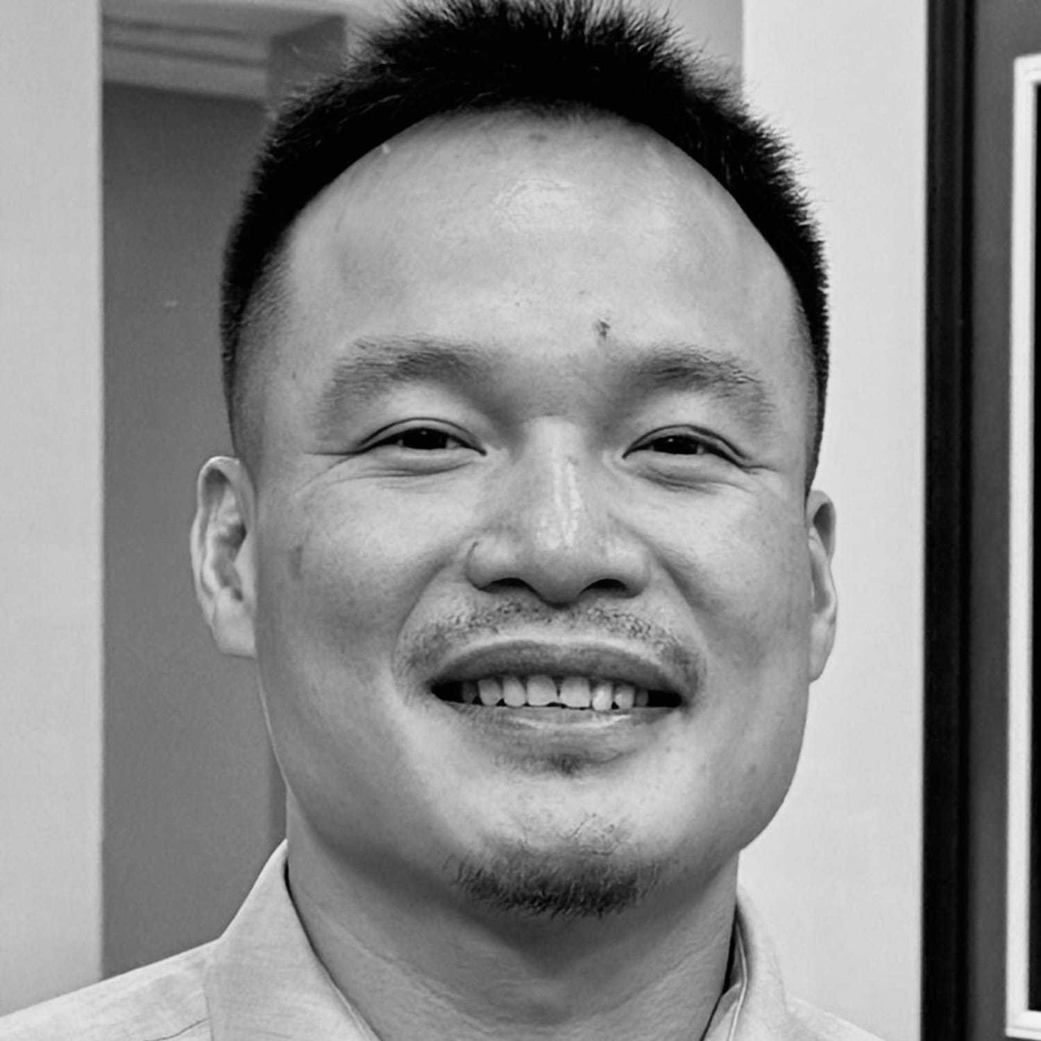 Portrait of Khoa, a professional stylist at The Robert Andrew Salon & Spa Collection, showcasing their expertise and style.