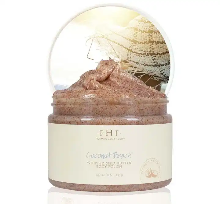 Coconut Beach whipped shea butter body polish in a jar with a beach-themed background.