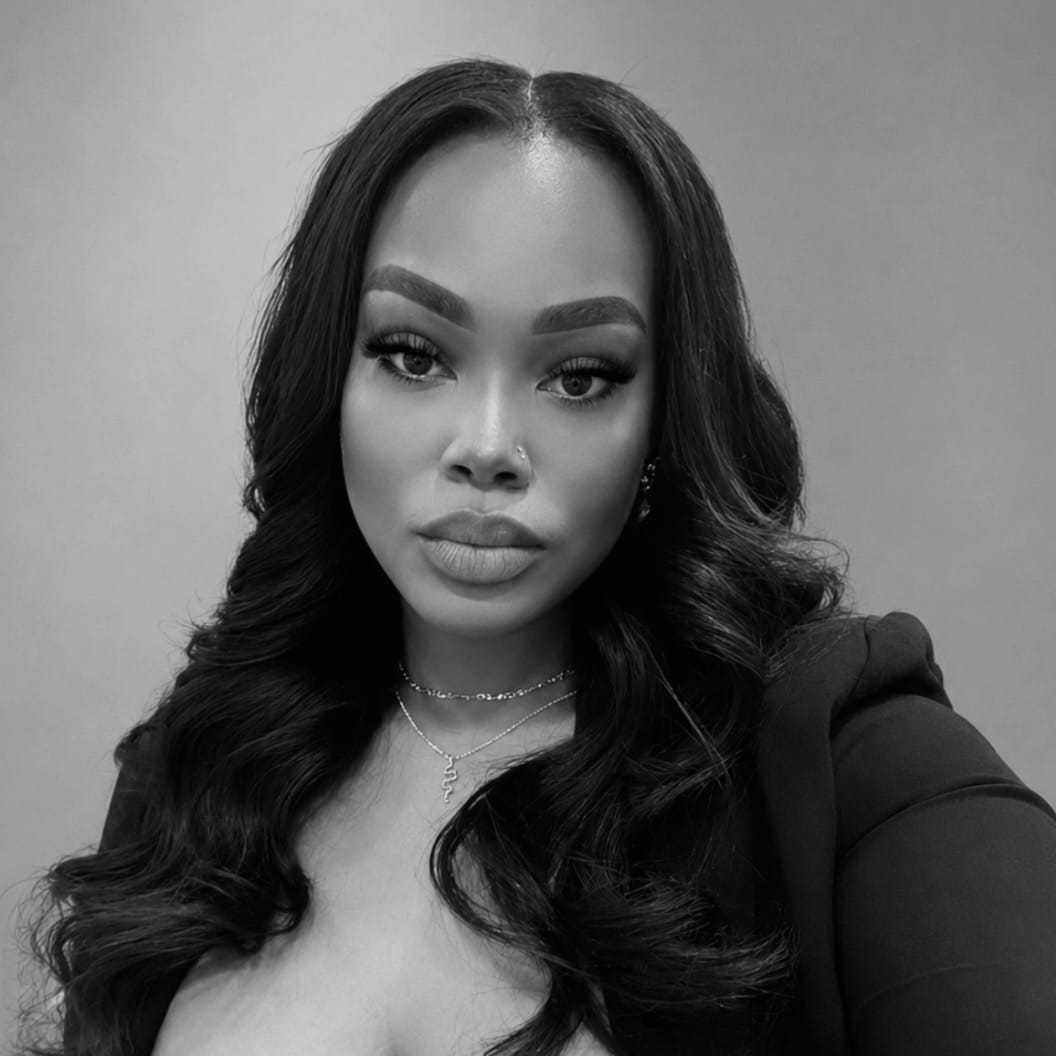 Portrait of Tanika, a professional stylist at The Robert Andrew Salon & Spa Collection, showcasing their expertise and style.
