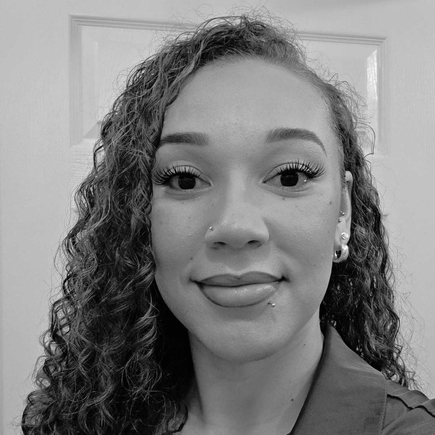 Portrait of Tiffany, a professional stylist at The Robert Andrew Salon & Spa Collection, showcasing their expertise and style.