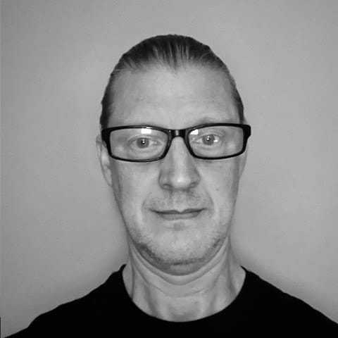 Portrait of Robert, a professional stylist at The Robert Andrew Salon & Spa Collection, showcasing their expertise and style.