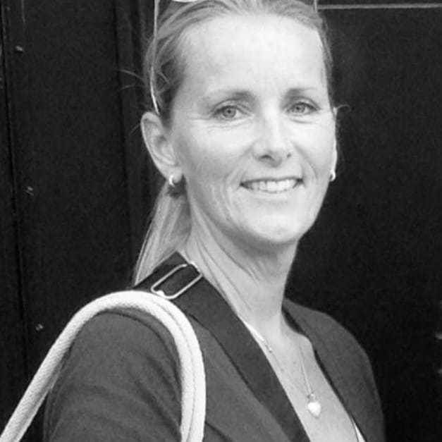 Portrait of Monique, a professional stylist at The Robert Andrew Salon & Spa Collection, showcasing their expertise and style.